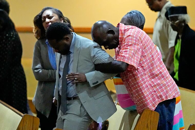 Parishioners pray during a service for the victims of a mass shooting at the St. Paul A.M.E. Church on Sunday in Jacksonville, Fla.