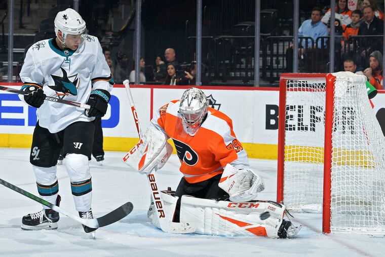 Flyers goaltender Carter Hart, shown making a save as the San Jose Sharks' Dylan Gambrell looks on in a Feb. 25 game, will play the first two periods in Tuesday's exhibition game against Pittsburgh in Toronto.