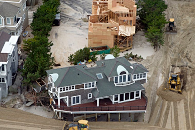 At Harvey Cedars, bulldozers went to work moving sand back into a dune formation Thursday. CLEM MURRAY / Staff Photographer