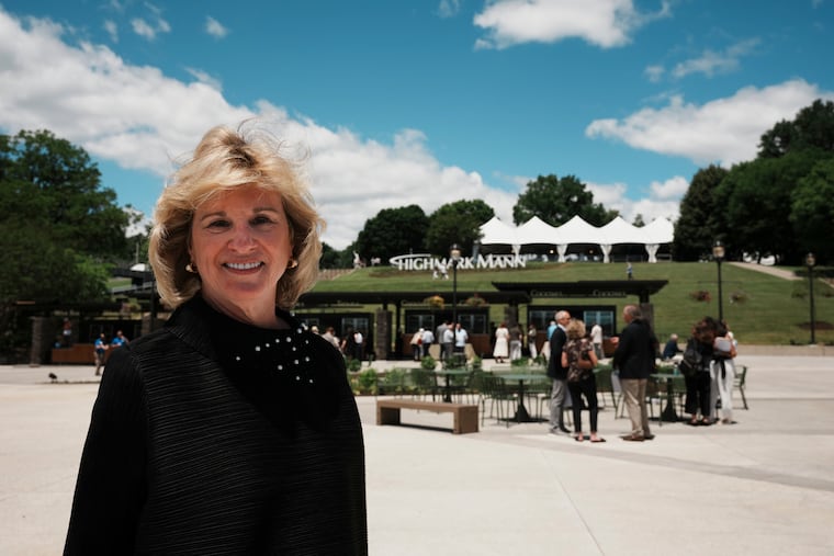Highmark Mann president and CEO Catherine M. Cahill in the center's new plaza with the "Hollywood"-style "Highmark Mann" sign in the background.