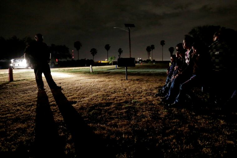 In this June 25, 2014 file photo, a group of immigrants from Honduras and El Salvador, who crossed the U.S.-Mexico border illegally, are stopped in Granjeno, Texas. During the longest-ever government shutdown, the federal judiciary has remained open, allowing the wheels of justice to keep turning in most criminal cases. In November, after a federal judge in California blocked the Trump administration from enforcing a ban on asylum for immigrants who illegally cross the southern border, government attorneys hurriedly asked a federal appeals court, then the U.S. Supreme Court, to suspend the order, terming illegal border crossings an "ongoing and increasing crisis." Both courts denied the government's request.
