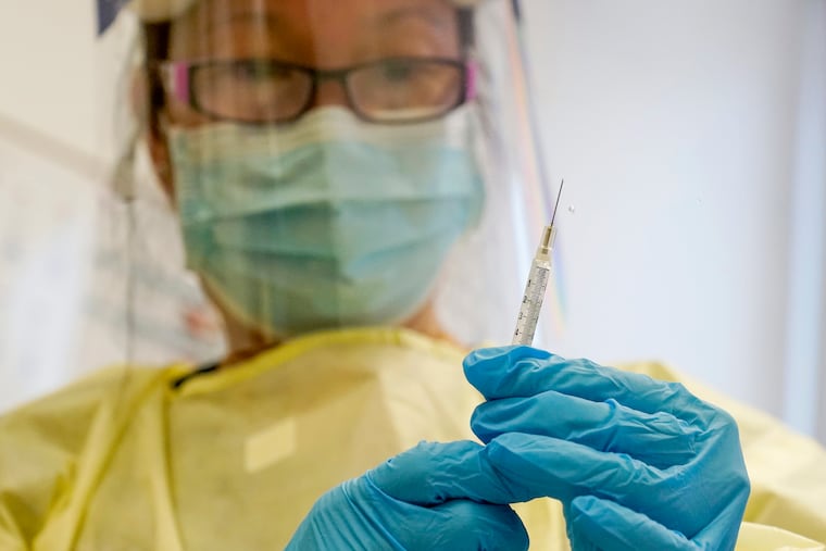 A physician assistant in New York prepares a syringe with the mpox vaccine in 2022.