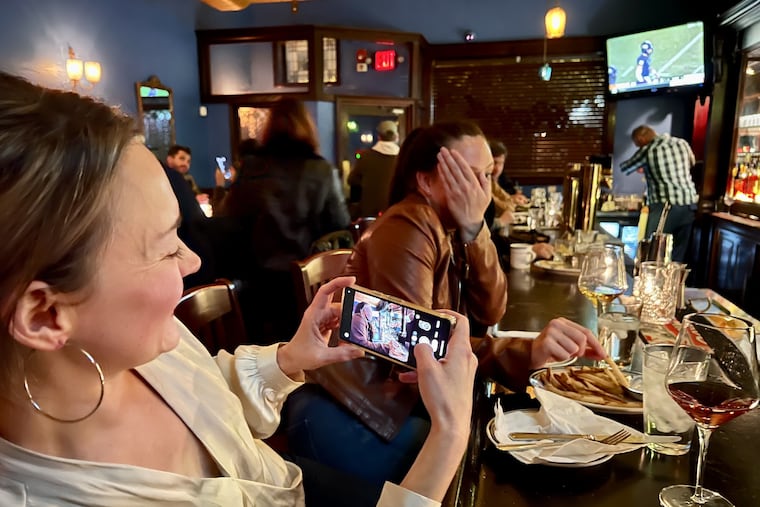 Ashley O'Neal tries to photograph her friend Leslie Hoff, who playfully rebuffs her, at Royal Tavern, 937 E. Passyunk Ave.