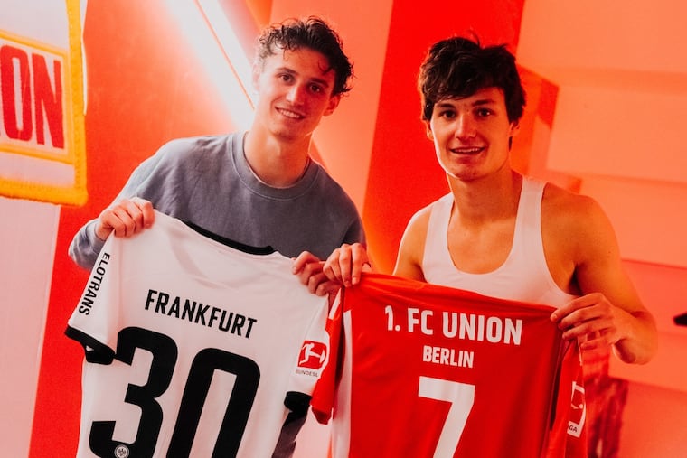 Brenden Aaronson (left) and Paxten Aaronson pose with each other's jerseys after the brothers played against each other for the first time as professional soccer players last weekend in Germany's Bundesliga.