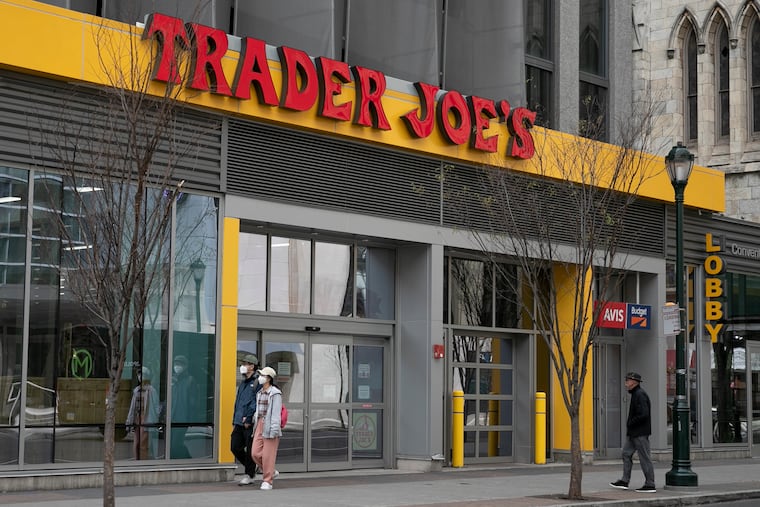 People walk by Trader Joe's at 13th and Arch Streets in Philadelphia in April 2020.
