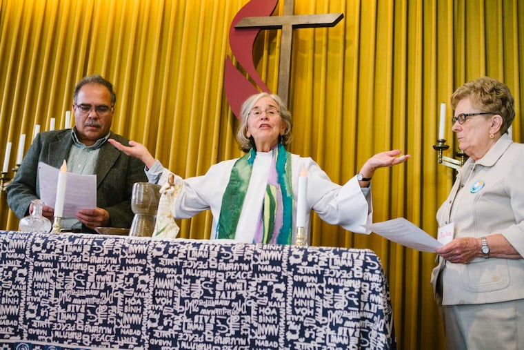 Eileen DiFranco welcomes the members of St. Mary Magdalene Community to communion along with her husband, Larry DiFranco, and Jackie Casper Agostini in Palmyra, New Jersey on Sunday, November 6, 2016.