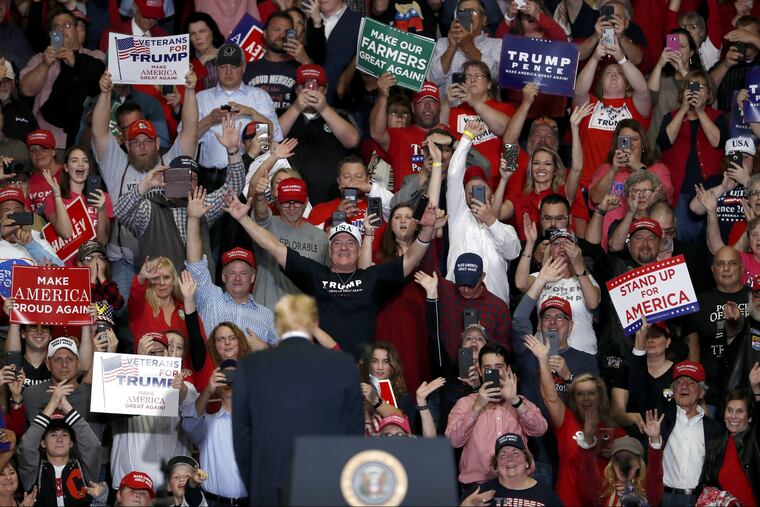 Members of the audience cheer as President Donald Trump leaves the stage at the end of a campaign rally Mondayin Cape Girardeau, Mo.