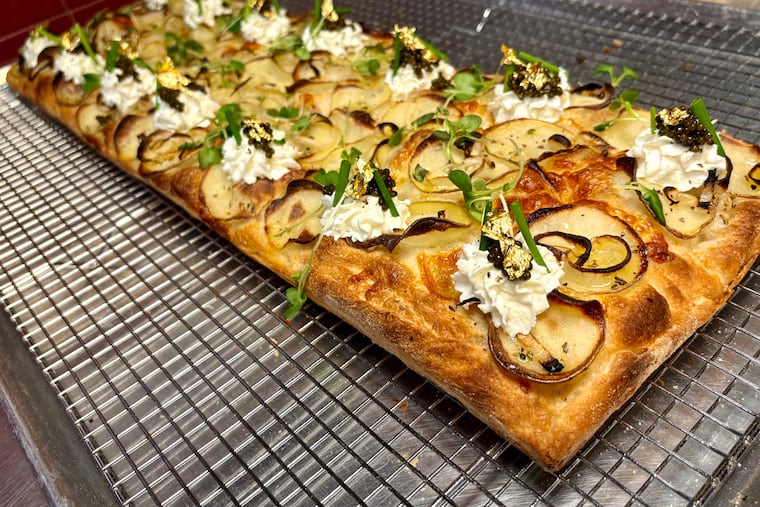 This Roman al taglio pizza topped with baby potatoes, Meyer lemon ricotta, caviar and edible gold at Pizzata Pizzeria near Fitler Square is a replica of the pie that one its co-owner, Davide Lubrano Lavadera, second place in the Roman pan division of the Pizza Expo competition in Las Vegas.