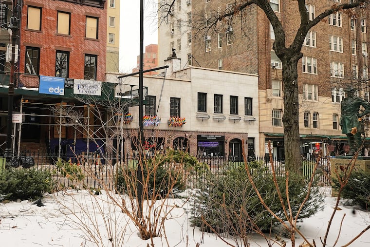 The Trump administration has stopped flying a rainbow flag on the pole, center, in the Stonewall National Monument, adjacent to the Stonewall Inn, background center, in New York, Tuesday, Feb. 10, 2026.