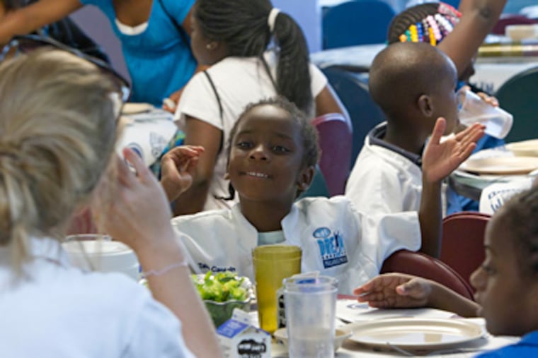 Imani White (center), 6, talks with Sara Fischer (back to camera), counselor at Girard College. (David M Warren / Staff Photographer)