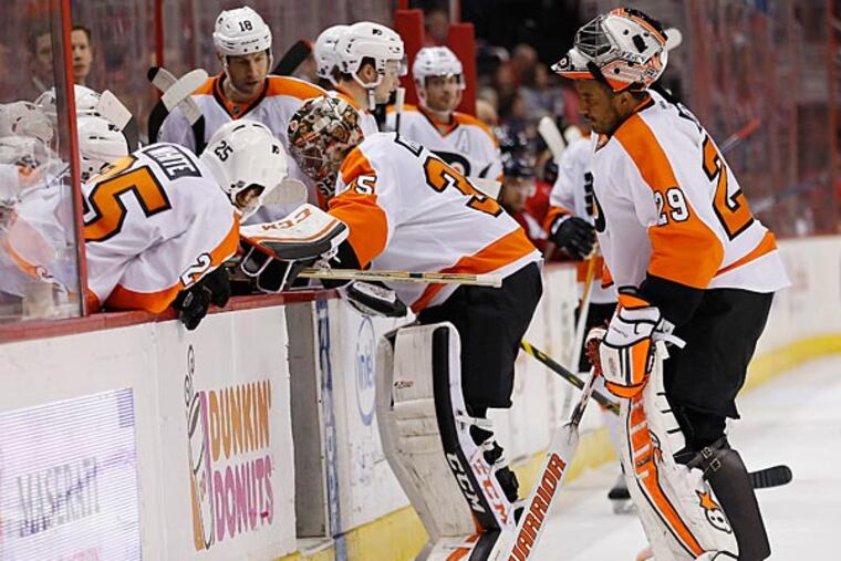 Philadelphia Flyers goalie Ray Emery (29) stands on the ice as Flyers goalie Steve Mason (35) leaves the ice after being injured against the Washington Capitals in the second period at Verizon Center. (Geoff Burke/USA Today)