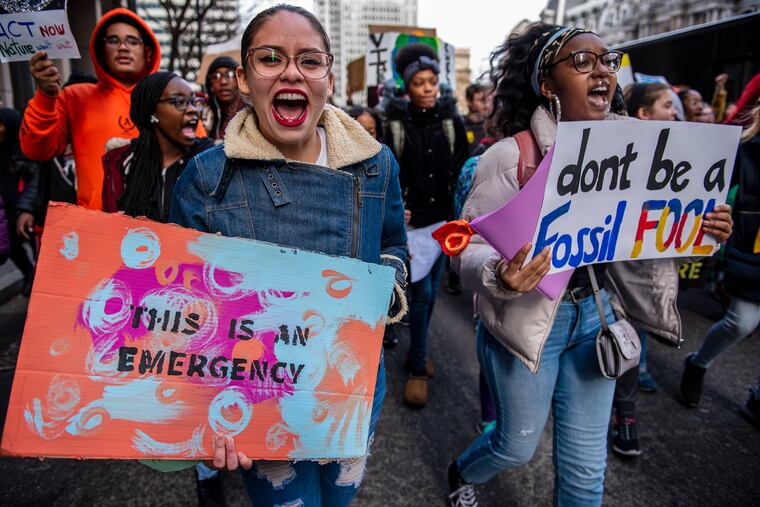 People march at the Youth Climate Change Strike at City Hall in Philadelphia on Friday, Dec. 6, 2019. Journalists will need to cover the climate crisis with the attention it gives to immediate disasters like COVID-19, write Mark Hertsgaard and Kyle Pope.