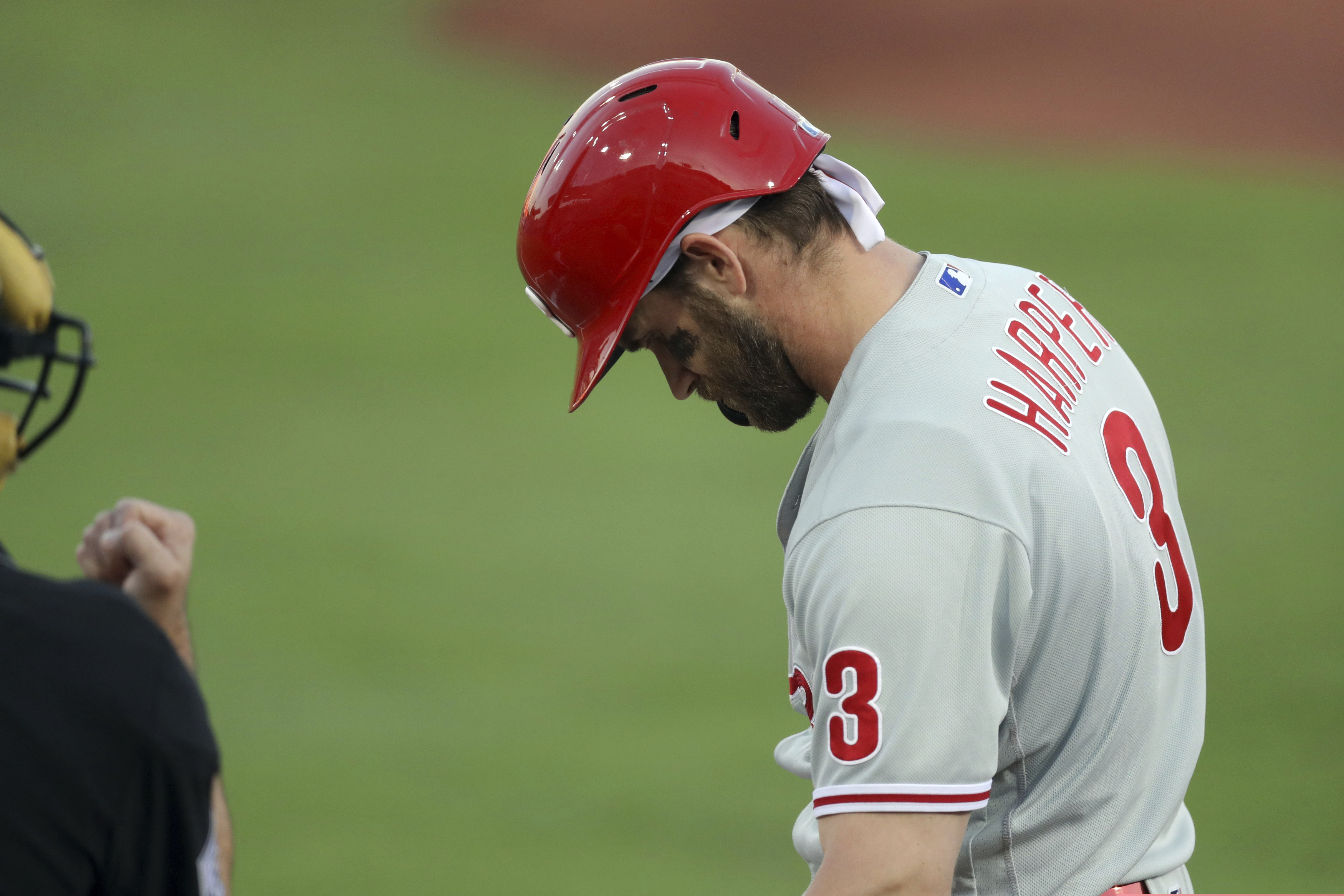 Bryce Harper looks down after being called out on strikes in the first inning Saturday night. Harper left the game in the fourth inning with a sore right shoulder.