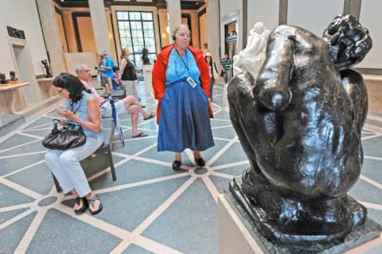 Folks visit the renovated Rodin Museum in Philadelphia on July 14, 2012. Here, Mary Lane Wark of Gumtree, PA, who traveled 50 miles to visit the Museum, takes in the sculpture. APRIL SAUL / Staff Photographer