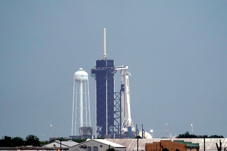 The SpaceX Falcon 9, with the Crew Dragon spacecraft on top of the rocket, sits on Launch Pad 39-A Wednesday, May 27, 2020, at Kennedy Space Center in Cape Canaveral, Fla. Two astronauts will fly on the SpaceX Demo-2 mission to the International Space Station scheduled for launch Wednesday afternoon. (AP Photo/David J. Phillip)