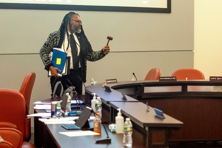 Reginald Streater picks up the gavel, as he moves to a new seat following his election as president of the Philadelphia School District board Thursday. Streater replaced longtime School Reform Commission and school board president Joyce Wilkerson.