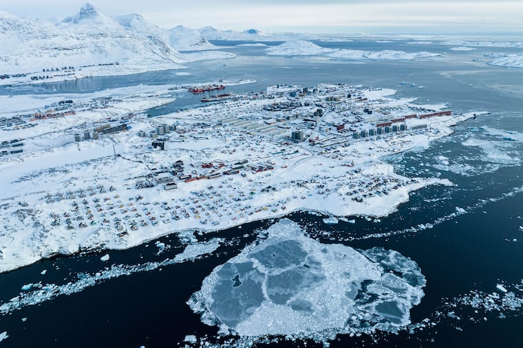 Houses covered by snow are seen on the coast of Nuuk, Greenland. The Trump administration is renewing its push to take over the large arctic island.