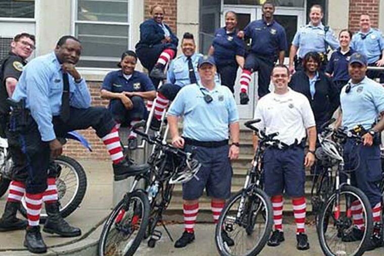 Police wear red and white socks for a fundraising effort for the Ronald McDonald House. (photo via Twitter)