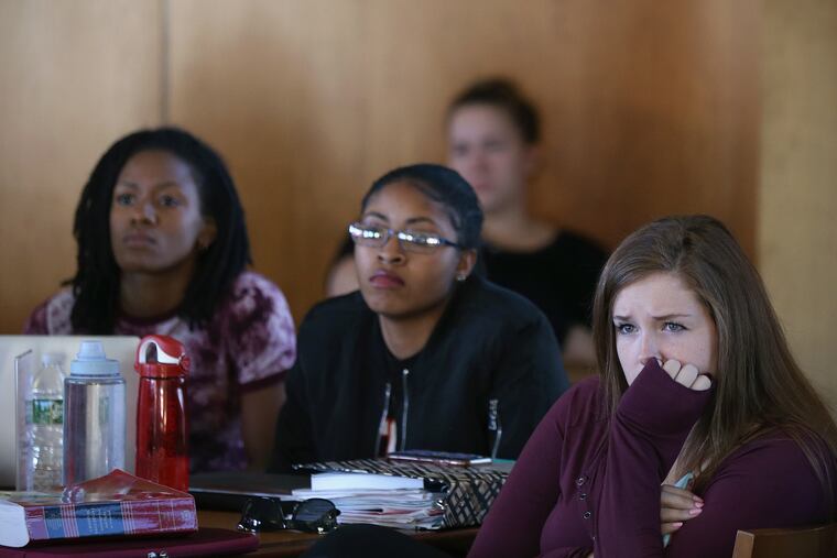 Kylie Finley, right, a second-year law student at Rutgers School of Law in Camden, N.J., watches Christine Blasey Ford testify before the Senate Judiciary Committee about her allegation that Supreme Court nominee Brett Kavanaugh sexually assaulted her, The law school set up a broadcast of the hearing for students to watch.