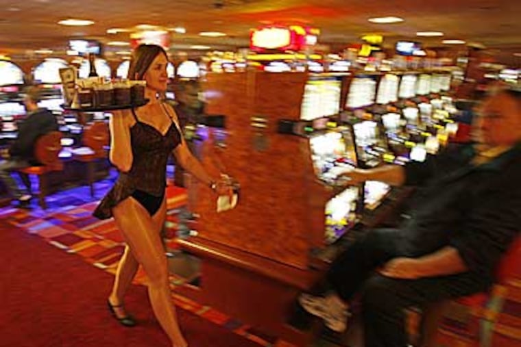 Diane Andrusko, manager of cocktail servers at PhiladelphiaPark Casino, serves drinks on the floor. The casino was the leader in revenue amoung among the seven operating Pennsylvania slots parlors. (Michael S. Wirtz / Staff )