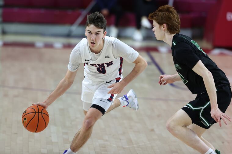 Penn's Clark Slajchert drives to the basket against Ryan Cornish of Dartmouth on Saturday.
