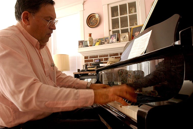 Casino piano tuner Charlie Birnbaum’s deft touch is reflected in the grand piano as he plays in the Atlantic City home that had belonged to his parents.