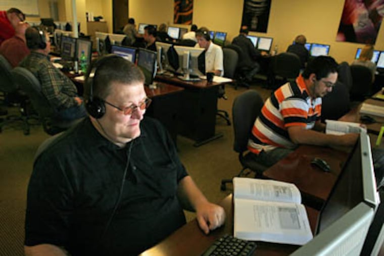 After being laid off in October, John Sparenberg, foreground, decided to earn his certification as a Microsoft-certified systems engineer, as pictured here June 5, in Dallas, Texas. (Melanie Burford / The Dallas Morning News)