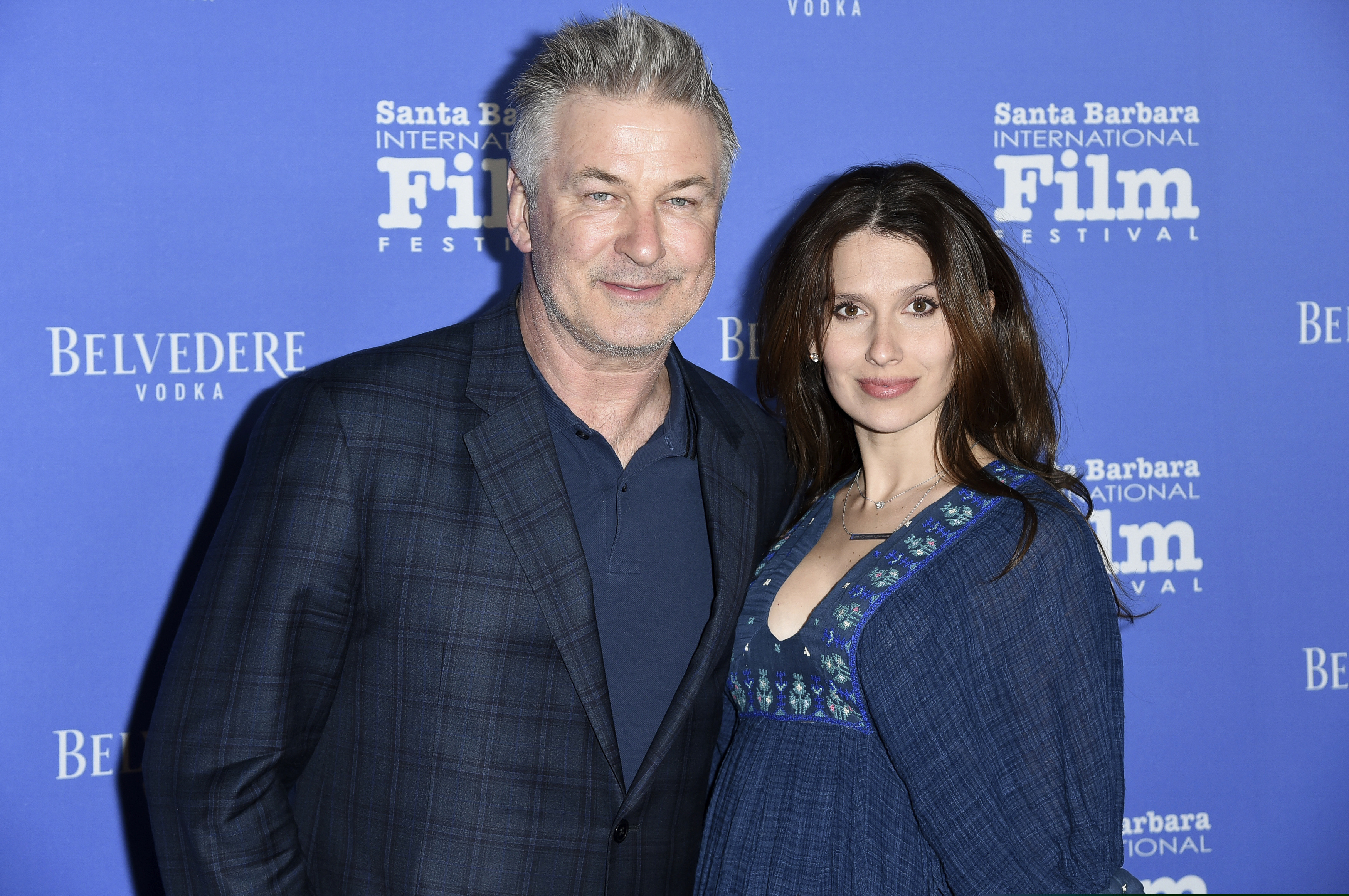 FILE - This Jan. 31, 2018 file photo shows Alec Baldwin, left, and Hilaria Baldwin at the Santa Barbara International Film Festival in Santa Barbara, Calif. Baldwin says he fell for a scam Statue of Liberty tour where he says he bought $40 tickets for a boat tour of the Statue of Liberty for his family but was instead escorted to a shuttle bus to New Jersey. He says his family ultimately ended up taking the Staten island Ferry, which is free and passes the Statue of Liberty. (Photo by Richard Shotwell/Invision/AP, File)