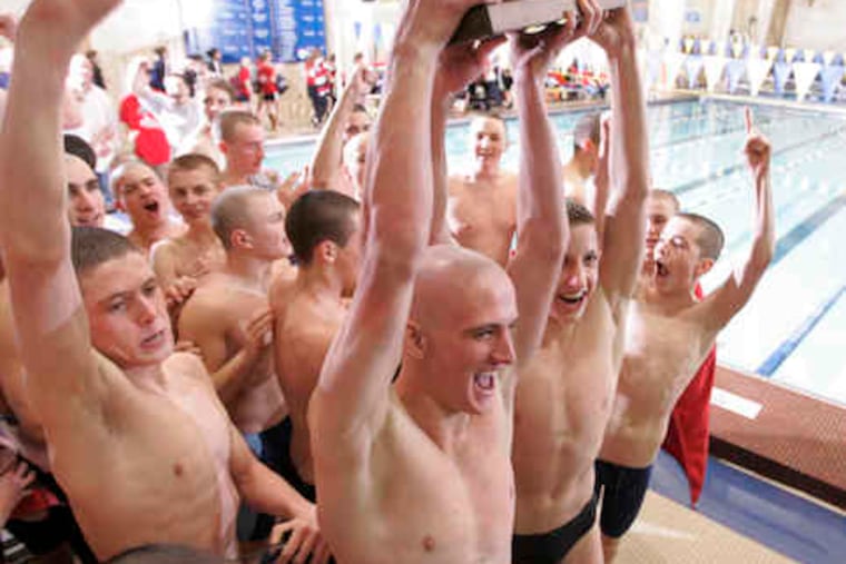 After years of frustration, the Haddonfield boys' swimmers finally got to hoist the state trophy. Here, the hardware is hefted by Greg Lee (shaved head) and Tommy Glenn after the win.