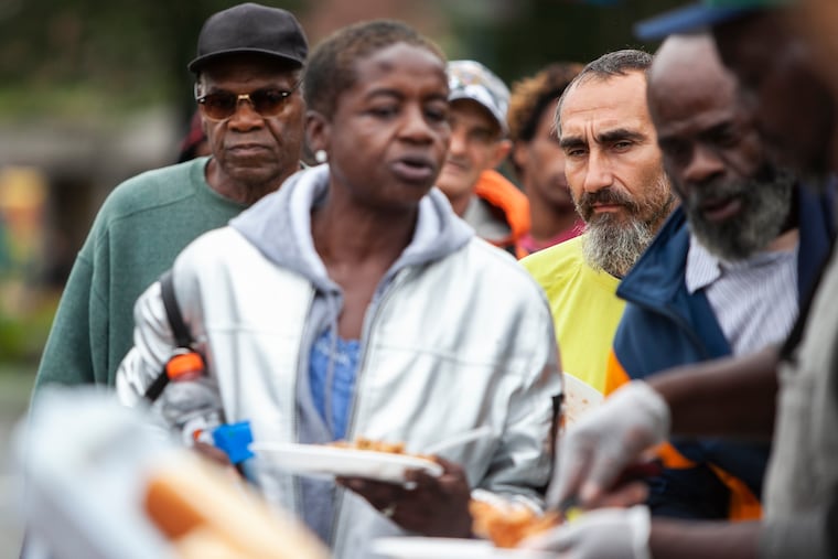 People wait in line for free food from a program called Philly Restart at 19th and the Ben Franklin Parkway on Monday afternoon, Sept. 10, 2018.