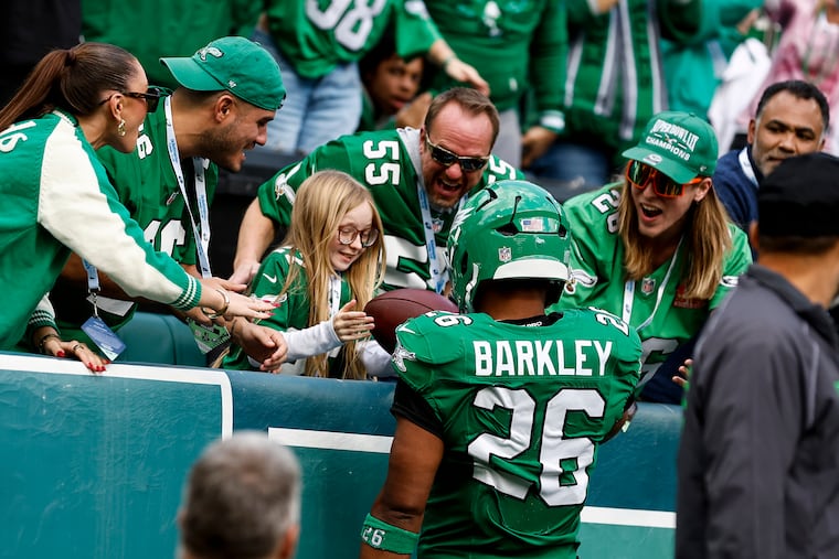 Eagles running back Saquon Barkley gives his second-quarter touchdown ball to 11-year-old superfan Ellie Kunkle in the Birds' Oct. 26 win over the Giants.