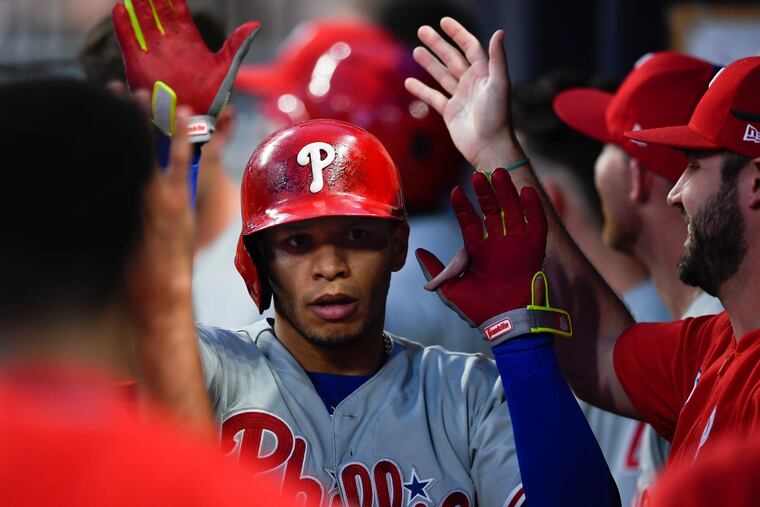 Phillies second baseman Cesar Hernandez is congratulated in the dugout after hitting a solo home run during the fourth inning against the Braves.