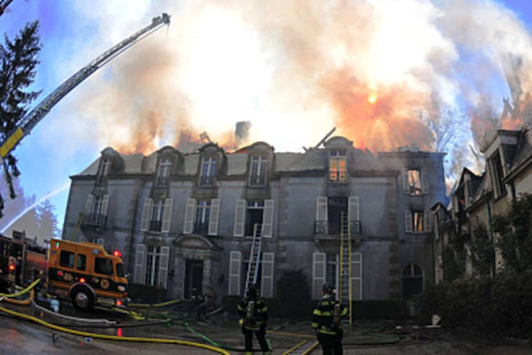 The mansion in flames in April. Radnor's fire marshal declared the fire's cause undetermined but not suspicious. (Luke Rafferty/Staff)