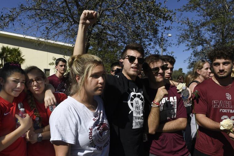 Marjory Stoneman Douglas High School students, staff, parents, friends and community leaders gather for a moment of silence in Parkland, Fla., on Thursday, Feb. 15, 2018, in the wake of a shooting that left 17 dead a day earlier. (Taimy Alvarez/Sun Sentinel/TNS)