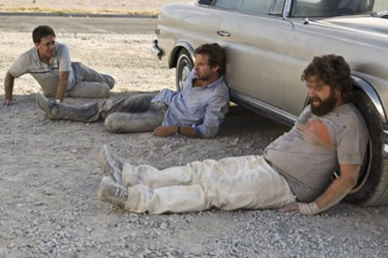 Zach Galifianakis, right, Bradley Cooper, center, and Ed Helms are shown in a scene from "The Hangover." (Frank Masi/AP/Warner Bros.)