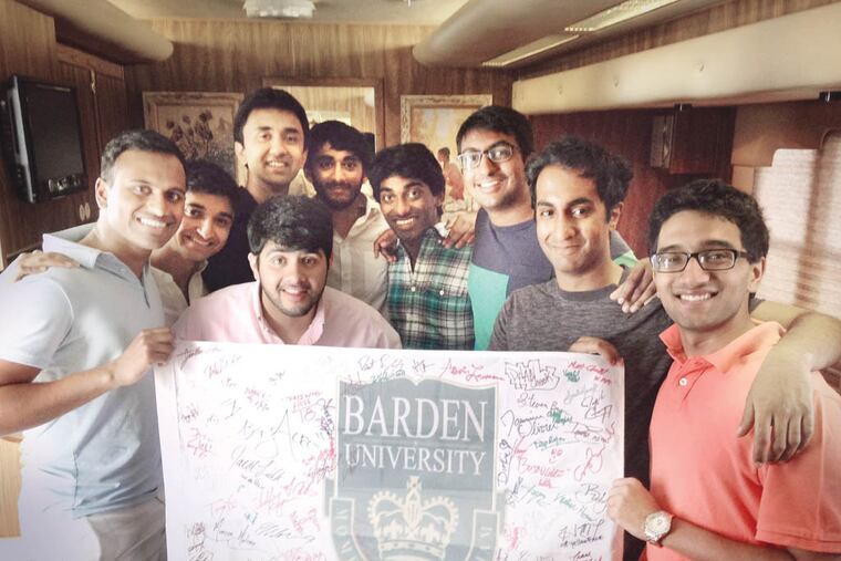 Penn Masala, an a capella group from the University of Pennsylvania, displays the banner they received for their cameo in “Pitch Perfect 2.”