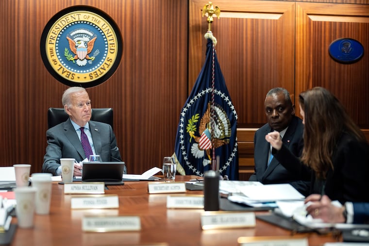 In this image provided by The White House, President Joe Biden receives the Presidential Daily Briefing on Monday, Jan. 29, 2024, in the White House Situation Room at the White House in Washington, as Defense Secretary Lloyd Austin listens.