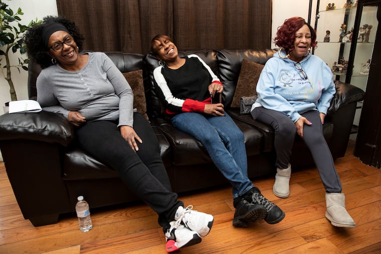Debra Herbin, Monica Thornton and Shirley Carter laugh while speaking with a reporter at Thornton's home in West Philadelphia. The Ultimates recorded "Why I Love You" in 1971. Brewerytown Records is re-releasing the album.