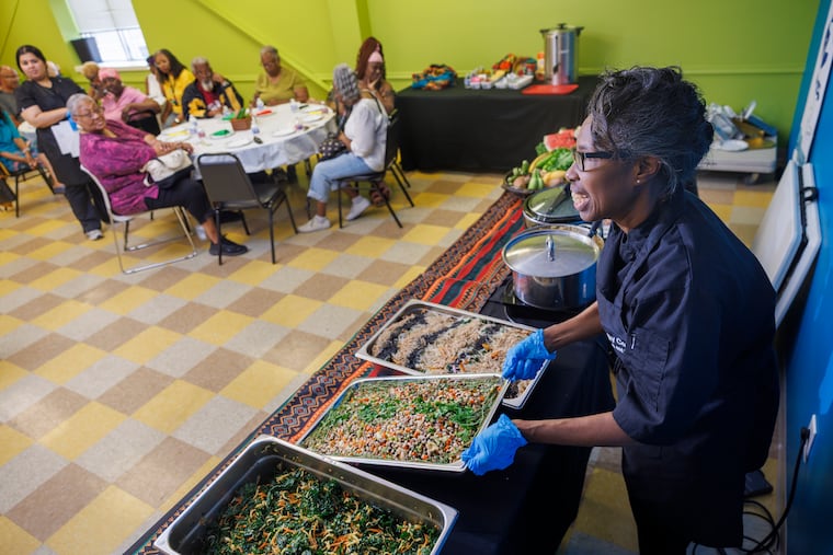 Johnetta Frazier, chef and lead culinary instructor at the Frazier Family Coalition for Stroke Education and Prevention, holds a tray of black-eyed pea salad at a recent luncheon at the organization's North Philadelphia headquarters.