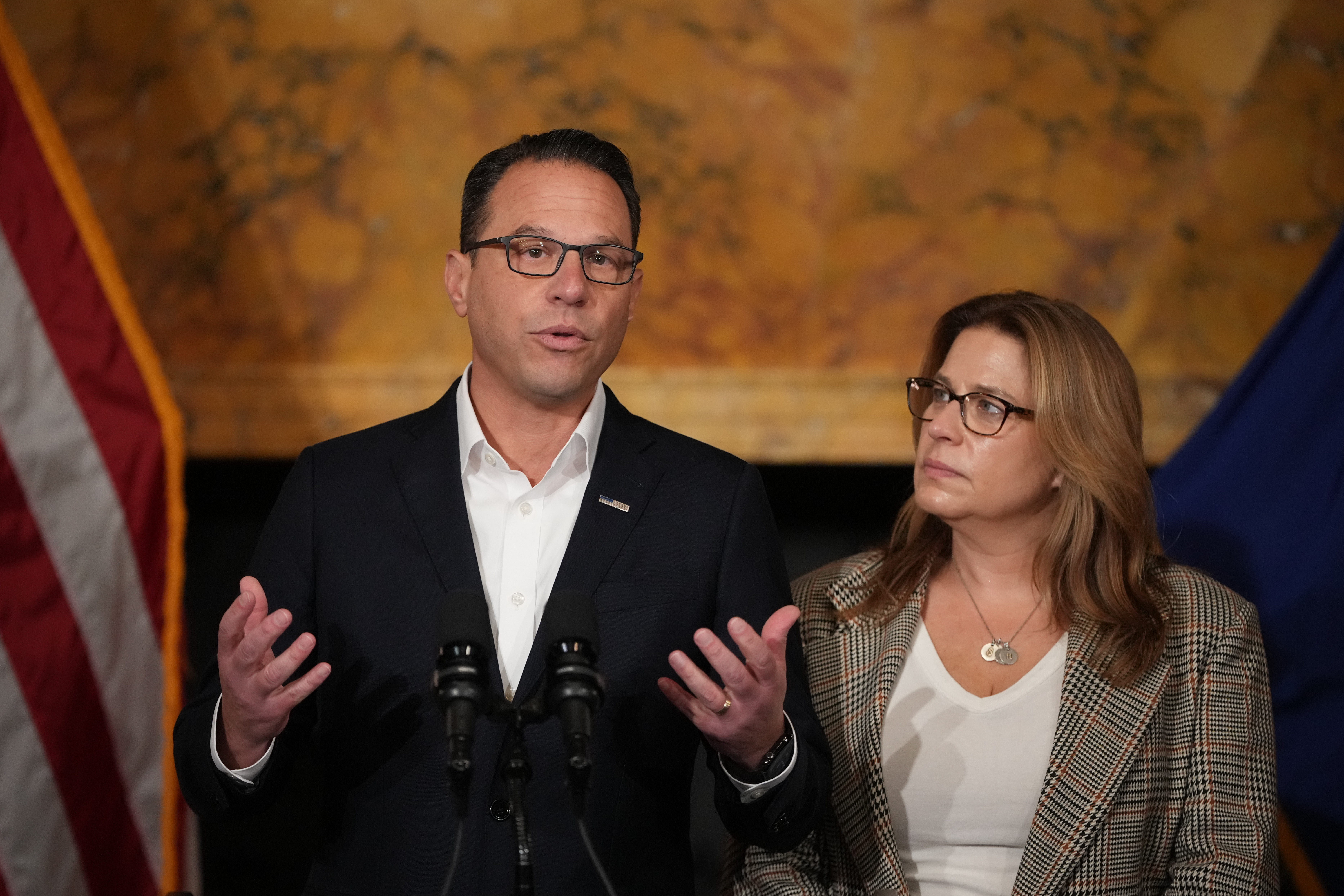 Pennsylvania Gov. Josh Shapiro, accompanied by his wife Lori Shapiro, speaks during a news conference after Cody Balmer pleaded guilty to attempted murder and other charges, on Tuesday, Oct. 14, 2025 in Harrisburg, Pa. (AP Photo/Matt Slocum)
