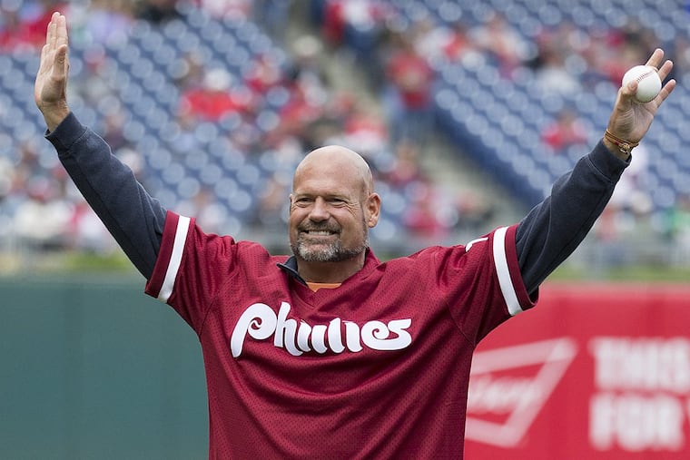Former Philadelphia Phillies’ Darren Daulton comes out for the “First Pitch” prior to the first inning of a baseball game against the Cincinnati Reds, Sunday, May 15, 2016, in Philadelphia.