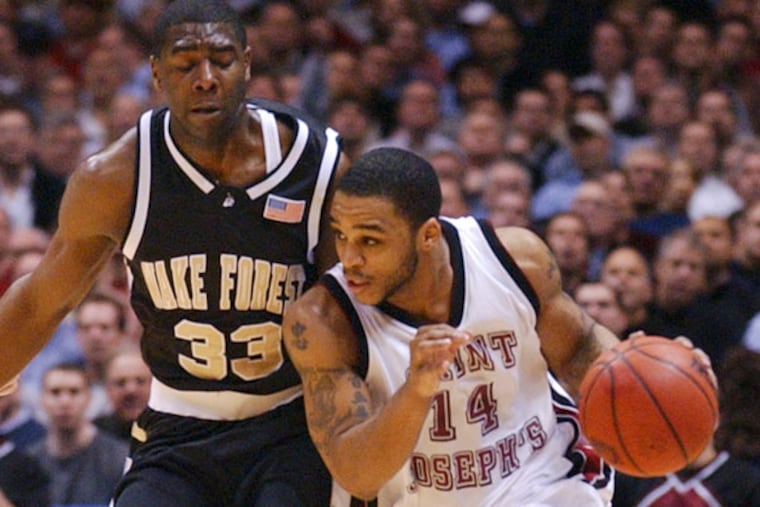 Jameer Nelson (14) dribbles up court as Wake Forest's Trent Strickland defends during the first half of their NCAA men's basketball championship regional game Thursday, March 25, 2004, in East Rutherford, N.J. (Bill Kostroun/AP)
