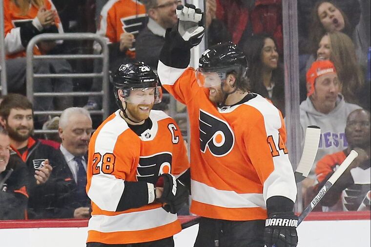Flyers center Claude Giroux (left) celebrates his second-period power play goal with Sean Couturier against the New York Rangers on Saturday.