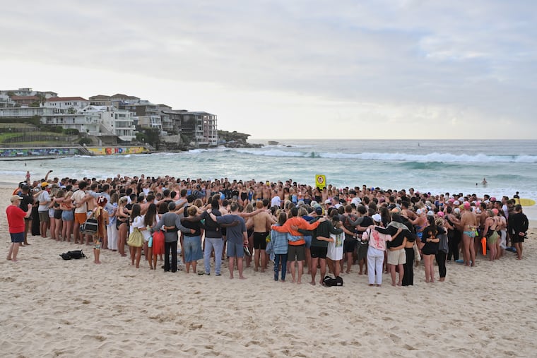 Swimmers gather for a morning vigil in Sydney on Wednesday following Sunday's shooting at Bondi Beach.