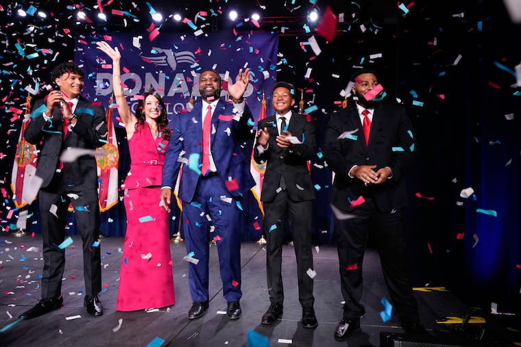 Florida Republican gubernatorial candidate Byron Donalds (center) waves next to his wife Erika, while standing on stage with their children Darin (left) Damon (second from left), and Mason during at a primary election party Tuesday in Orlando.
