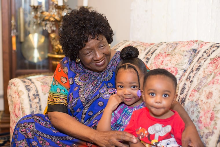 Sharonell Fulton, one of the plaintiffs in the case who has fostered more than 40 children through Catholic Social Services, sits beside two of her foster children.