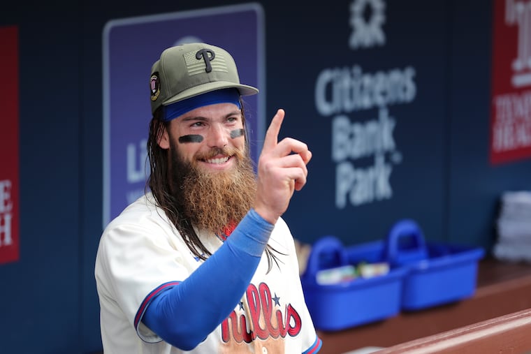 Philadelphia Phillies center fielder Brandon Marsh gestures at a teammate.