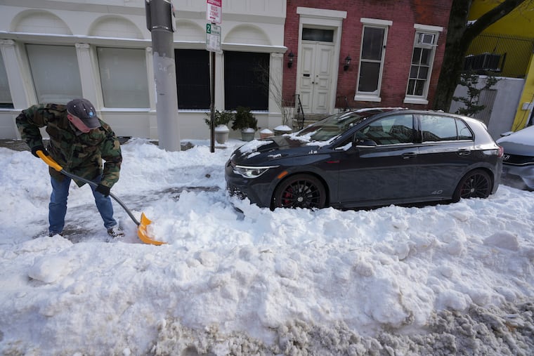 Fred Scheuren shovels snow at 12th Street, near Waverly Street, in Center City, Philadelphia, Monday, Jan. 26, 2026.