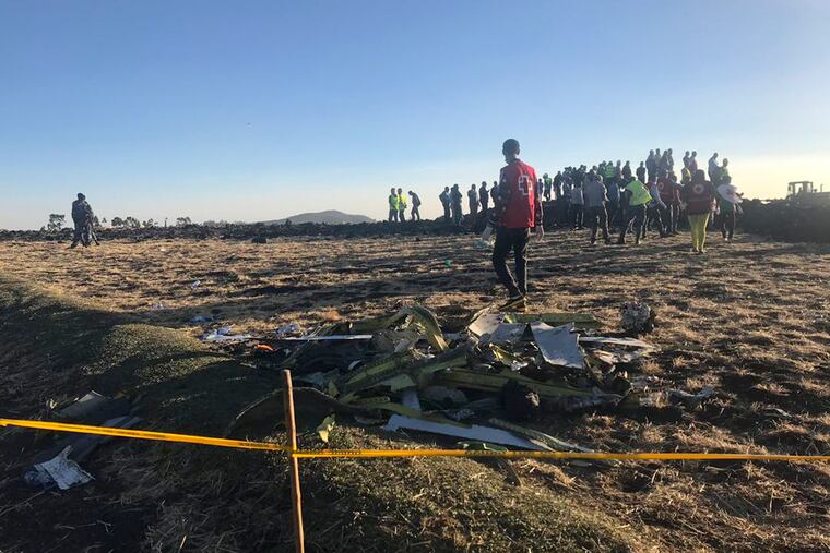 Rescuers search at the scene of an Ethiopian Airlines flight that crashed shortly after takeoff.
