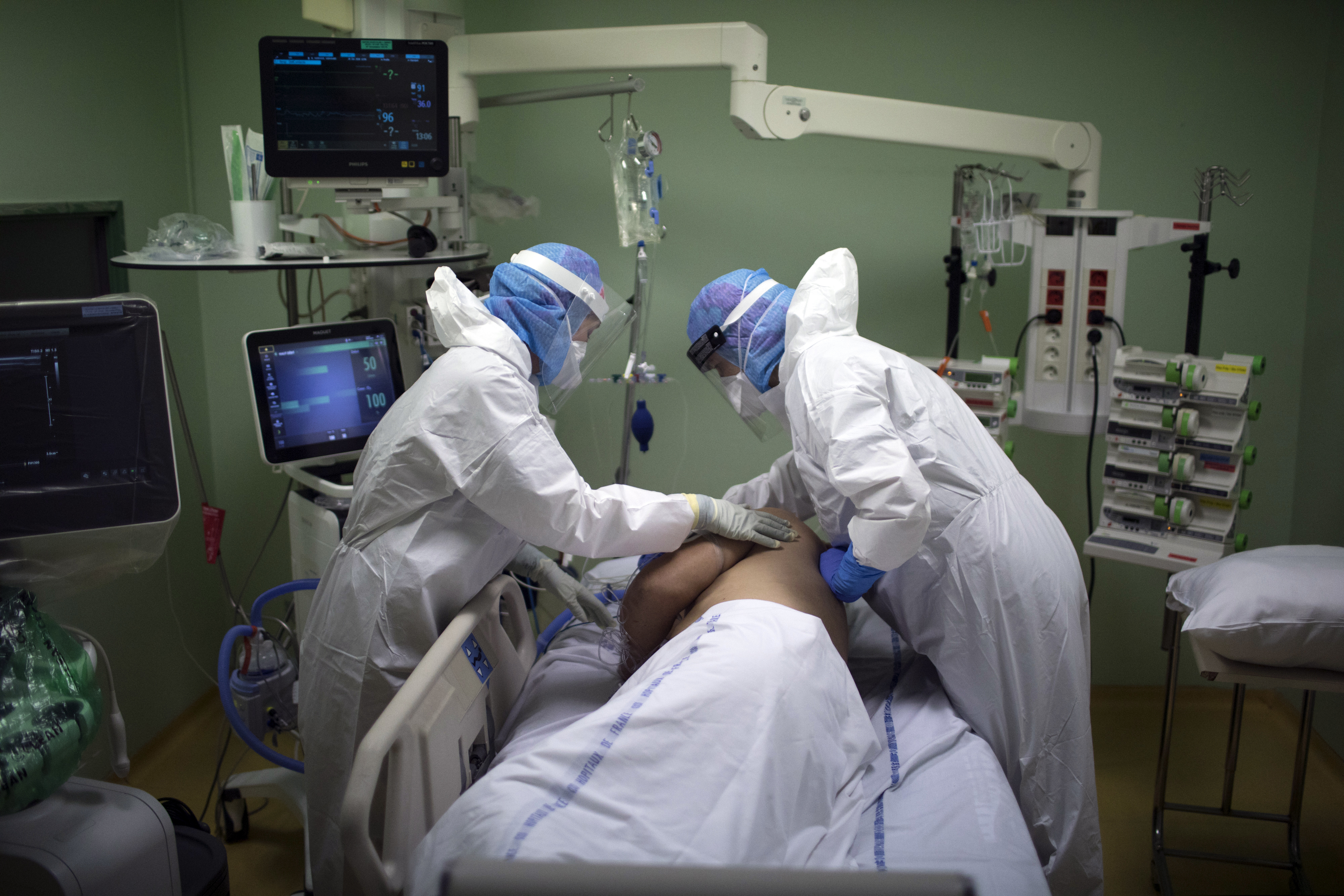 A medical crew treats a COVID-19 patient in the intensive care unit at the Joseph Imbert Hospital Center in Arles, southern France.